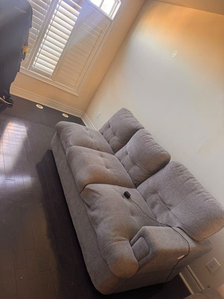 Grey couch in a room before pickup