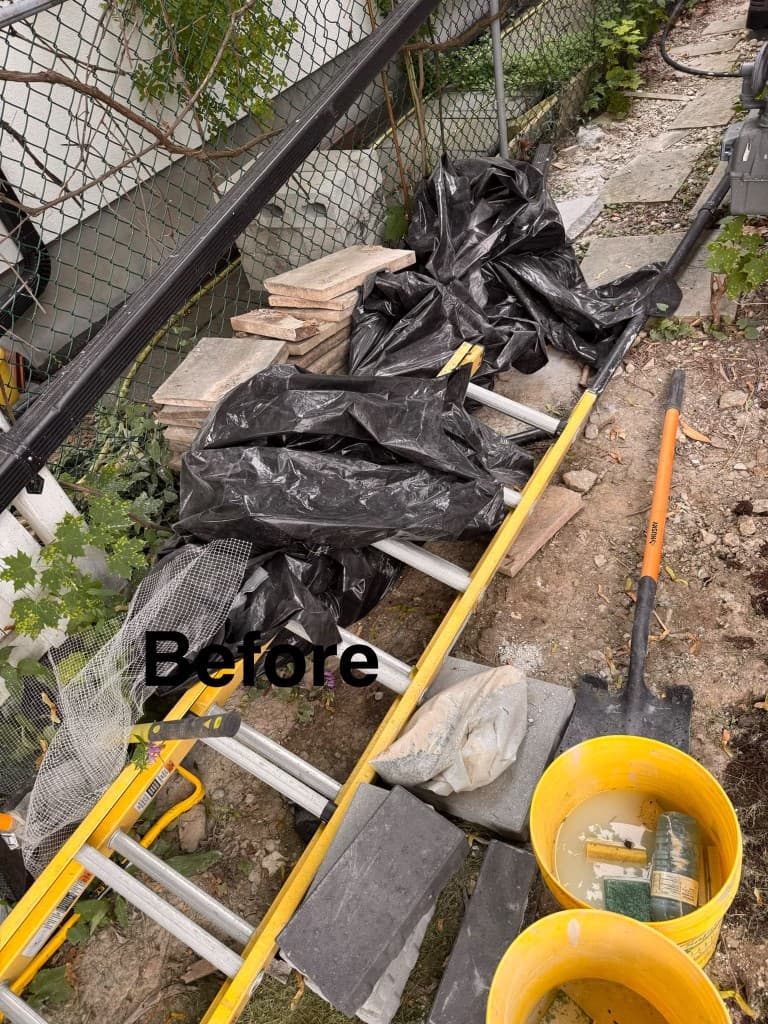 Before junk removal: side yard cluttered with trash bags, pavers, and renovation debris in the GTA